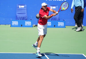 Kamil Majchrzak hits one during his quarter-finals match against Lorenzo Musetti at the Tata Open Maharashtra on Friday