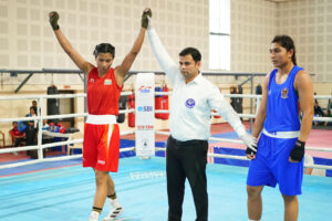 Lovlina Borgohain (red) celebrates after her 7-0 win against Pooja during the trials for Asian Games at Indira Gandhi stadium in Delhi on Monday