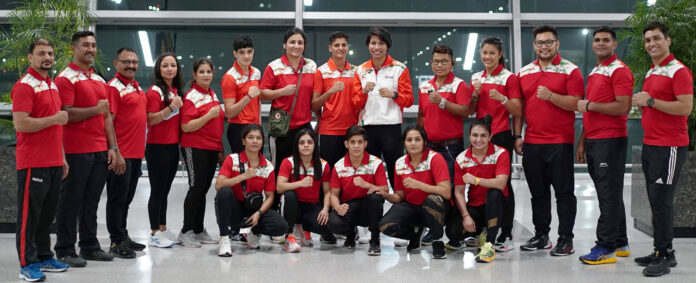 Indian women's boxing team pose at IG Airport in the early hours of thursday as they depart for Turkey to participate in training camp before the IBA World Championships