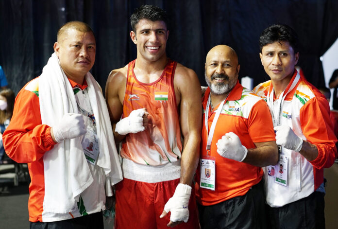 India's Sumit poses along with the coaches after winning the men's 75kg semi-final at the Thailand Open International Boxing Tournament in Phuket on Friday, April 8, 2022