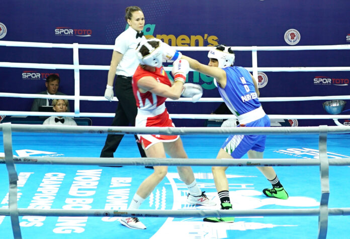 India’s Parveen (in Blue) punches Ukraine's Mariia Bova during the 63kg opening round match at the 12th IBA Women’s World Boxing Championships in Istanbul on Wednesday